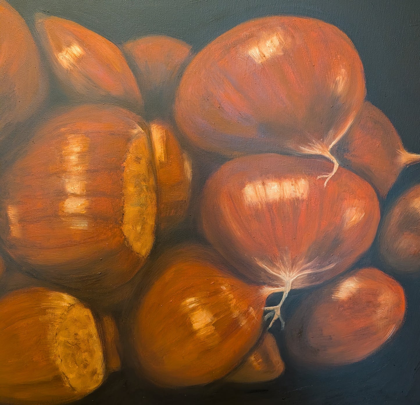 Detail of an oil painting of chestnuts on a dark background